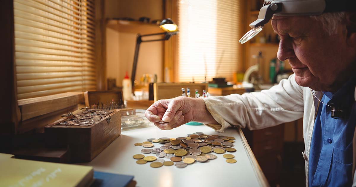 senior citizen looking at coins
