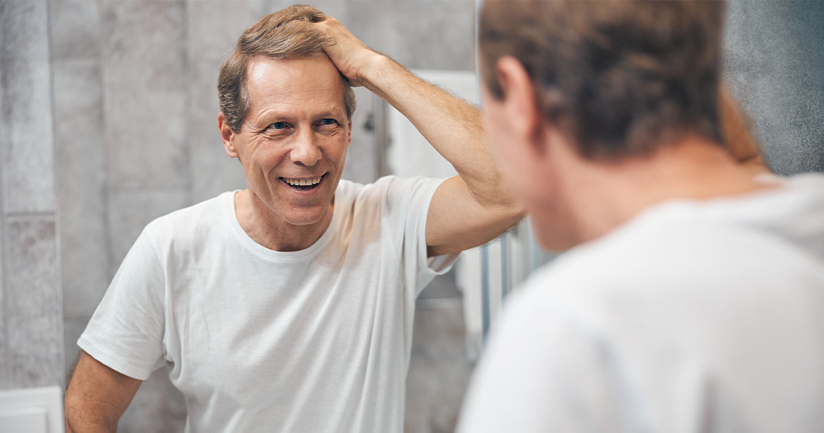man touching his hair