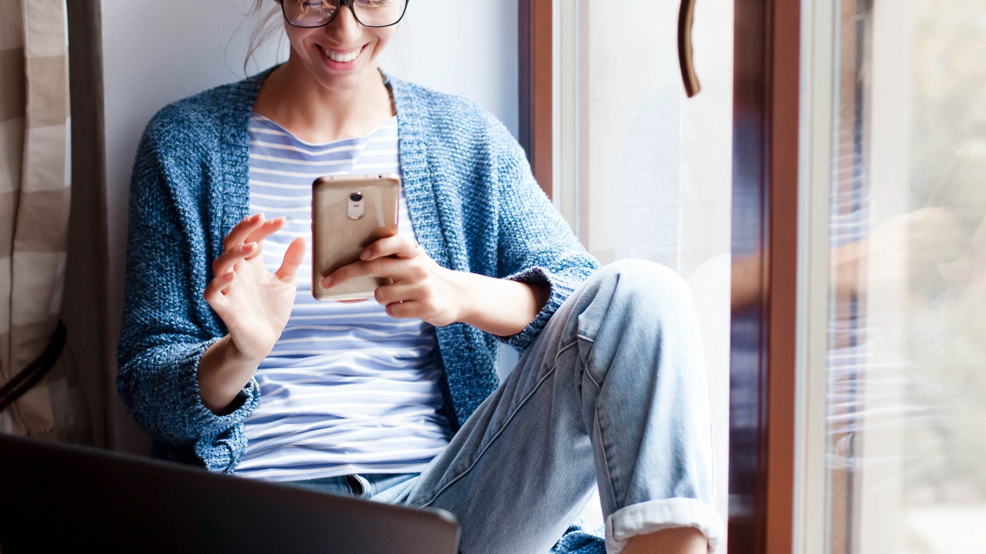 Shopper comparing products online using a phone and laptop