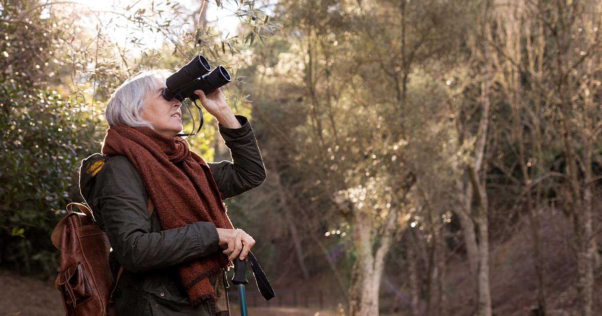 Woman bird watching with binoculars