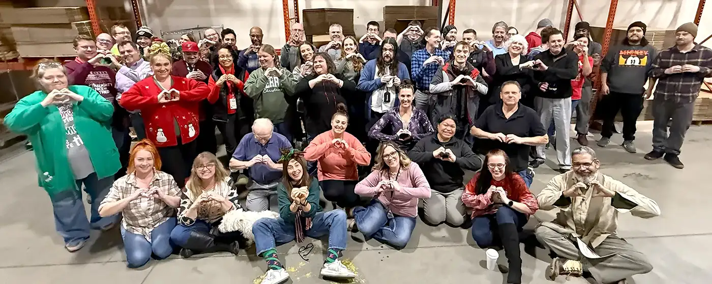 Heartland America employees giving heart hands symbol